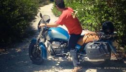 Man with red shirt on motorcycle