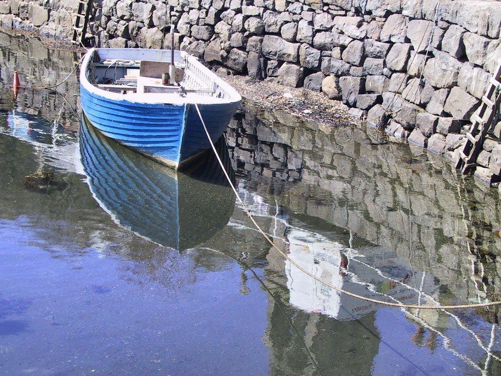 a moored blue boat a moored blue boat